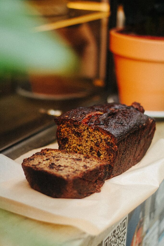 Delicious homemade banana bread loaf with a slice cut, inviting and ready to eat.