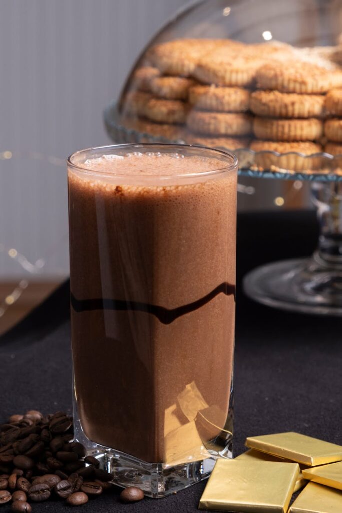 Rich chocolate milkshake with cream and biscuits, perfect for dessert lovers.