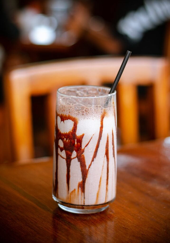 A tempting chocolate milkshake with drizzle, served in a cozy Oaxaca café setting.