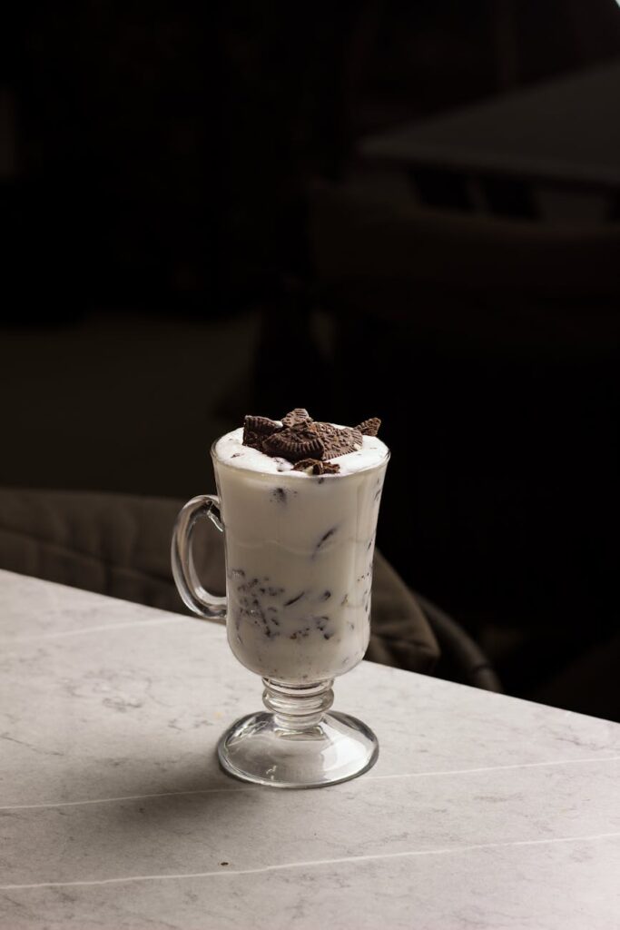 A delicious Oreo milkshake in a glass cup, perfect for dessert lovers.