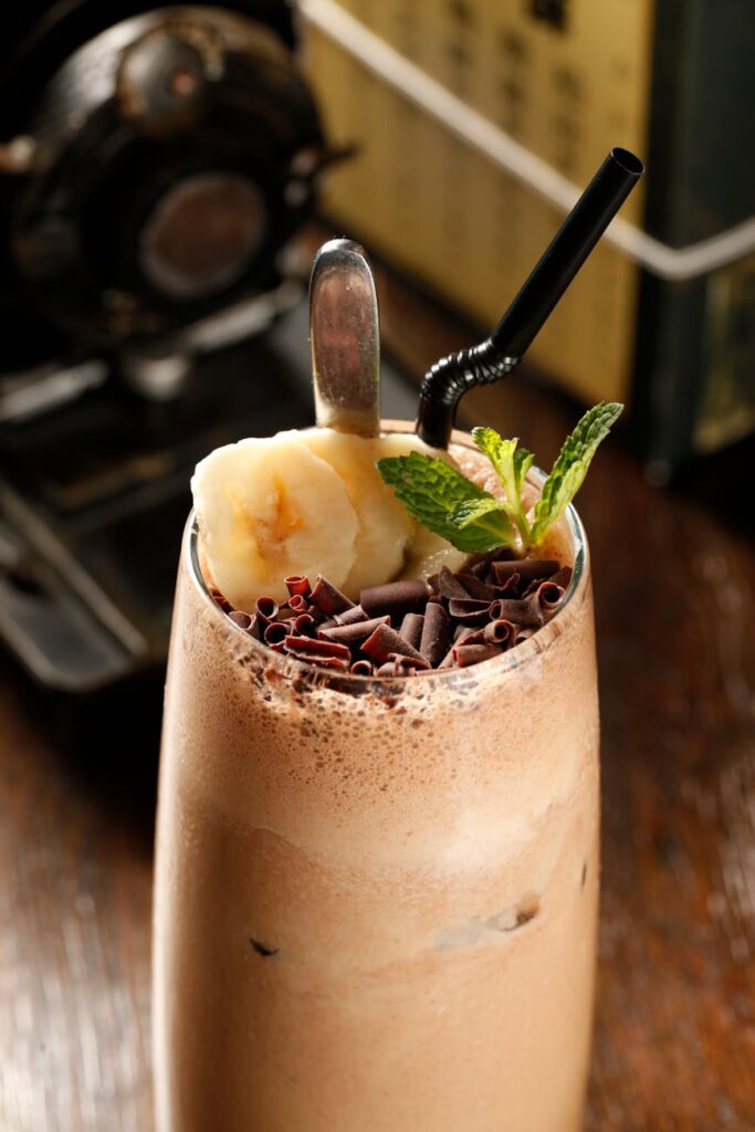 Indulge in a chocolate banana milkshake topped with chocolate curls and mint.